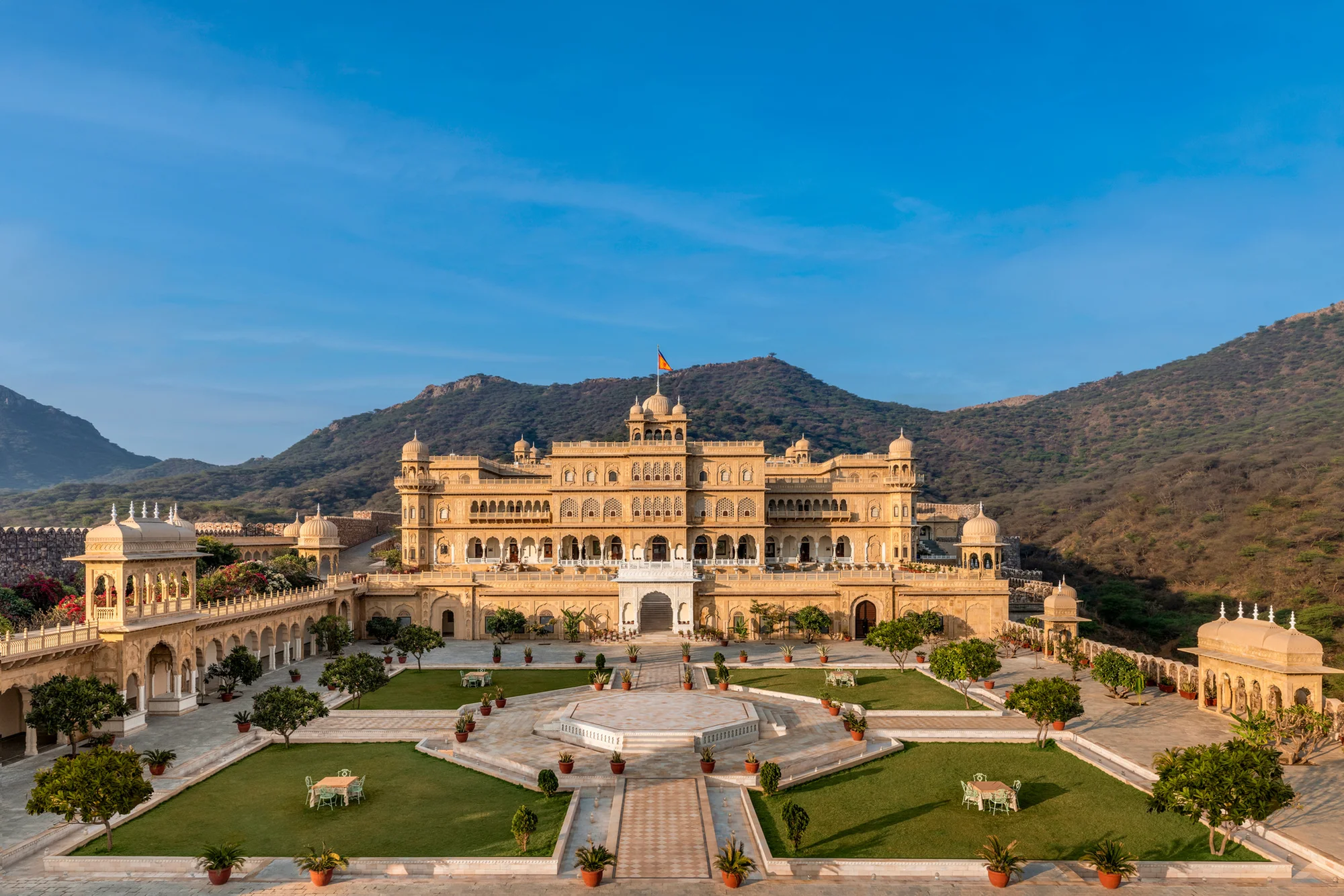 Golden Abheygarh palace and its garden courtyard, surrounded by the Aravalli hills